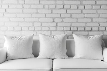Modern white couch with soft pillows arranged in front of bright white brick wall, minimal Scandinavian living room interior design, Generative AI