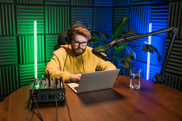 Handsome man radio DJ hosting a radio show, entertainment and communication concept