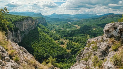 Naklejka premium Panoramic View of Lush Green Valley Surrounded by Rocky Cliffs