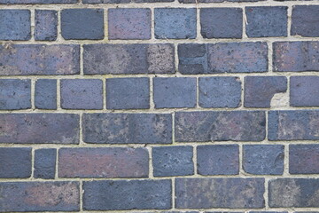 A brick wall with a blue brick color