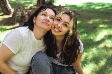 Fototapeta premium Smiling women enjoying a sunny day in the park surrounded by nature