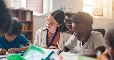 Write, education and teacher helping children in classroom for language development, learning or growth. Notebook, advice and woman educator with kid students for lesson at elementary school. © Jess B/peopleimages.com