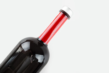 close-up of a bottle of red wine on a white