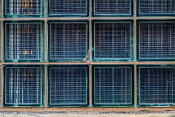 glass block wall with textured surface and visible crack.