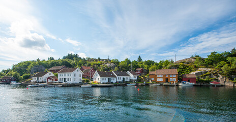 Fototapeta premium idyllic coastal village with calm waters and colorful houses.
