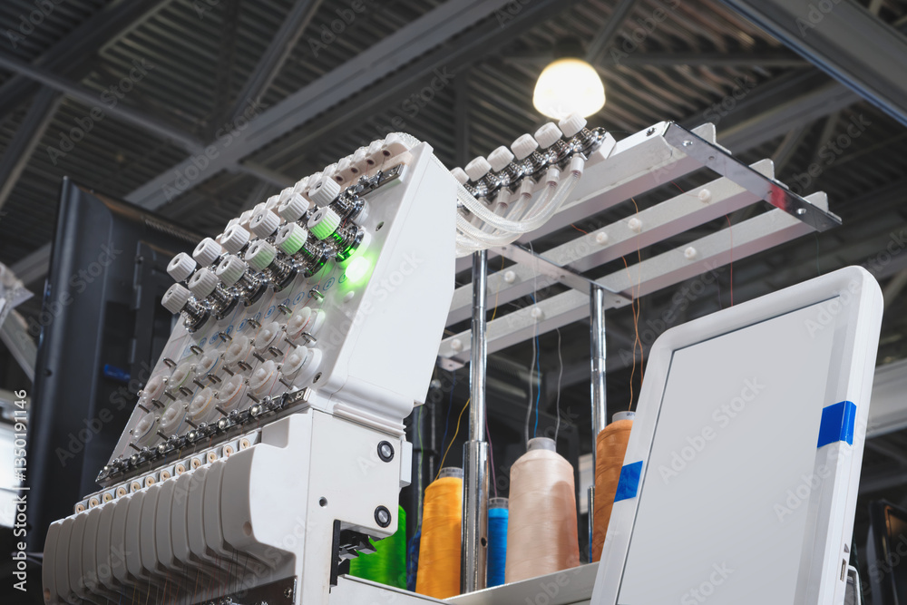 Leinwandbilder a machine is weaving a fabric with many threads. the machine is in a factory. concept of industry an