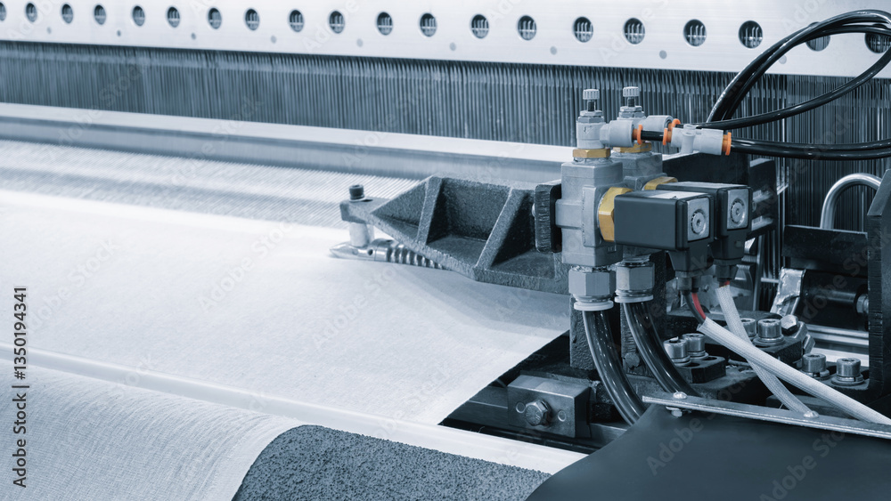 Aufkleber a machine is weaving a piece of fabric. the machine is made up of many parts, including a large meta