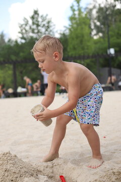 little boy playing on the beach