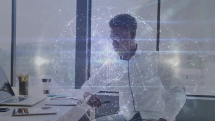At desk, business professional creating animation with digital network globe overlay - Powered by Adobe