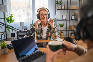 mature woman guest in podcast answering on questions to man host