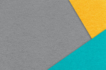 Fototapeta premium Texture of craft gray color paper background with yellow and turquoise border. Vintage abstract grey cardboard.