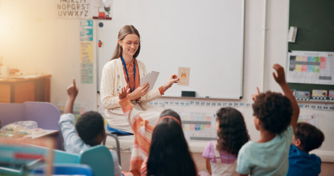 Teacher, children and flash cards with answer in lesson for animal questions, alphabet knowledge or feedback. Educator, people and students with hands raised for creative development or language quiz