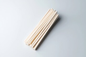 A stack of plain, off-white drinking straws