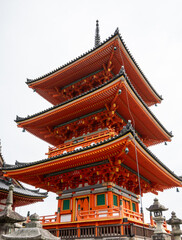 Elegant structure of Kiyomizudera's three-tiered vermilion pagoda. Its vermilion color symbolizes protection while green panels ward off evil. 