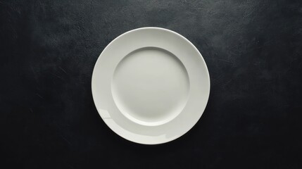 Empty white plate on dark table, overhead shot, minimalist background, food menu mockup