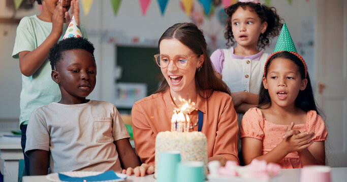 Teacher, woman and children with birthday cake at school, happy and celebration with snacks in classroom. Person, kids and excited with smile for dessert, cheers and singing for party at academy