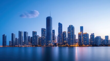 Fototapeta premium Stunning Cityscape of Tall Buildings with Reflection in Water Under Blue Hour Sky at Night