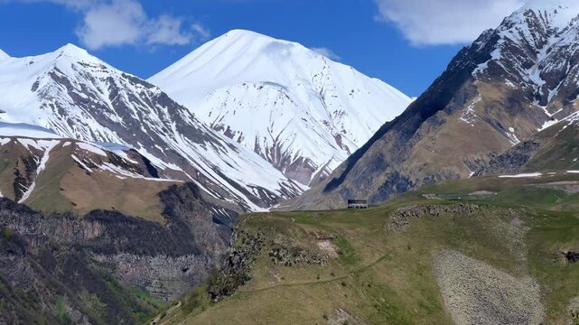 GUDAURI, GEORGIA - APRIL 26, 2024: Scenic view of the Devil's Gorge and the Arch of Friendship. The Caucasus Mountains in the area of the Peoples' Friendship Arch on the Georgian Military Road. 4K