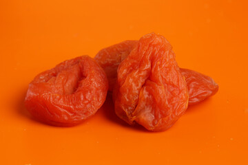 dried apricots on orange background