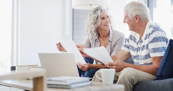 Senior, happy couple and documents with laptop for financial planning, profit or retirement annuity on sofa. Elderly man, woman or house with computer or paperwork for pension fund or home insurance