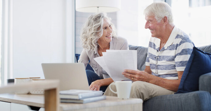 Sofa, senior couple and documents with laptop for financial management, laughing and retirement plan. Home, man and woman with digital for review, online savings or investment with paperwork in house