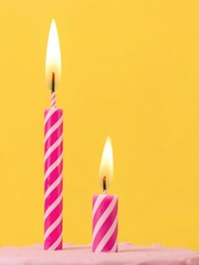 A vibrant pink striped birthday candle with a flickering flame burns brightly against a sunny yellow backdrop, happy, yellow, striped