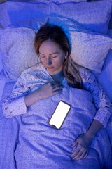 In a dim room lit only by the white glow of her phone, a woman fell asleep peacefully, placing her...