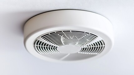 Close-up of a white ceiling-mounted ventilation fan for air circulation and exhaust purposes