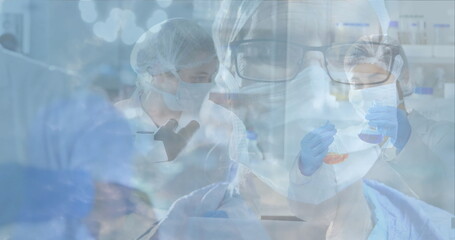 Scientists in laboratory wearing protective gear conducting research and experiments