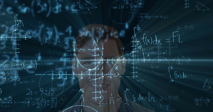 Focusing on complex calculations, man surrounded by mathematical formulas in school