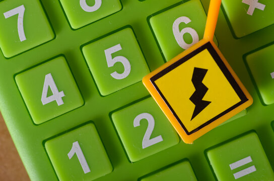 Economic Crisis Concept – Calculator and Power Outage Warning Sign