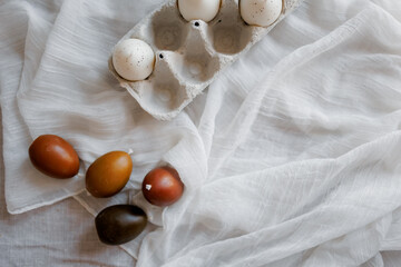 Easter table decorated with a homemade Easter cake on a stand, painted eggs and candles, morning light, natural colors, festive mood