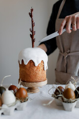 Easter aesthetics, minimalistic background, glazed pastries, candles in the form of Easter eggs, Spring mood of preparation for Easter celebration