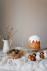 Easter aesthetics, minimalistic background, glazed pastries, candles in the form of Easter eggs, Spring mood of preparation for Easter celebration