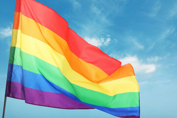 LGBT flag fluttering against beautiful blue sky