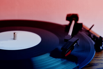 Turntable with vinyl record, closeup. Color toned