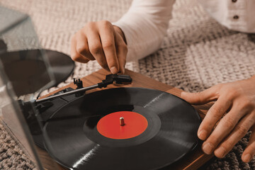 Man using turntable at home, closeup view