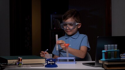 Young chemist is carefully pouring chemicals into a test tube while conducting a science experiment...