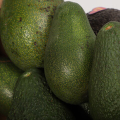 Close-Up of Fresh Ripe Avocados with Different Textures and Green Skins