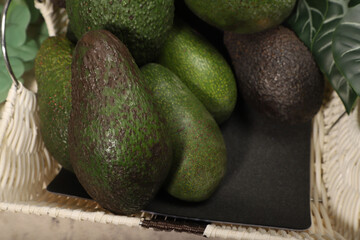 Fresh Ripe Avocados in a Basket with Decorative Greenery