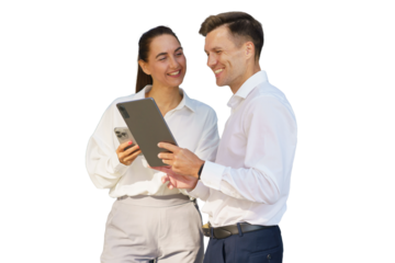 Colleagues engaging in a friendly discussion while using digital devices in an office setting