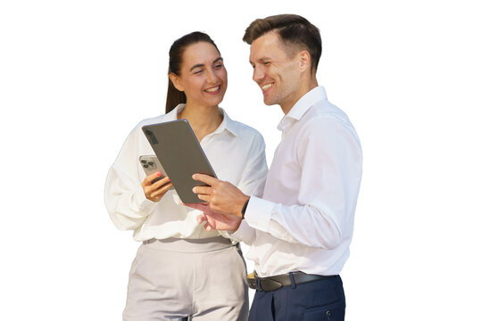 Colleagues engaging in a friendly discussion while using digital devices in an office setting