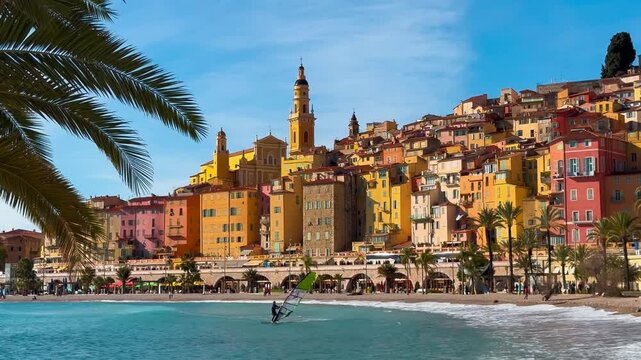 Colourful houses, palm trees on the embankment in Menton, Provence, Alps, Cote d'Azur France February 26, 2025. High quality 4k footage