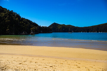 panorama of Stilwell Bay in Abel Tasman National Park. Little paradise beaches with turquoise water surrounded with tropical vegetation. Famous great walk in New Zealand South Island