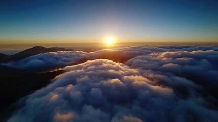 Fototapeta premium Sunrise above cloud-covered mountains