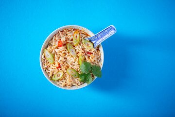 Traditional asian noodle soup served on blue background.
