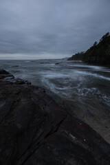 High tide water flowing into the rocky coastline.
