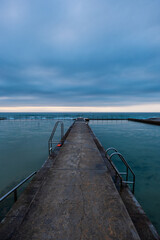 Fototapeta premium Cloudy morning view of Austinmer rock pool, Australia.