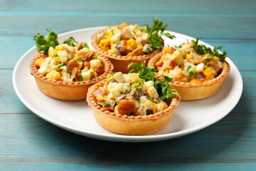 Tartlets with delicious filling on blue wooden table, closeup