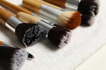 Clean makeup brushes on white table, closeup